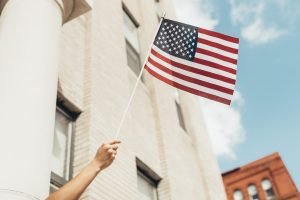 US flag waved from window