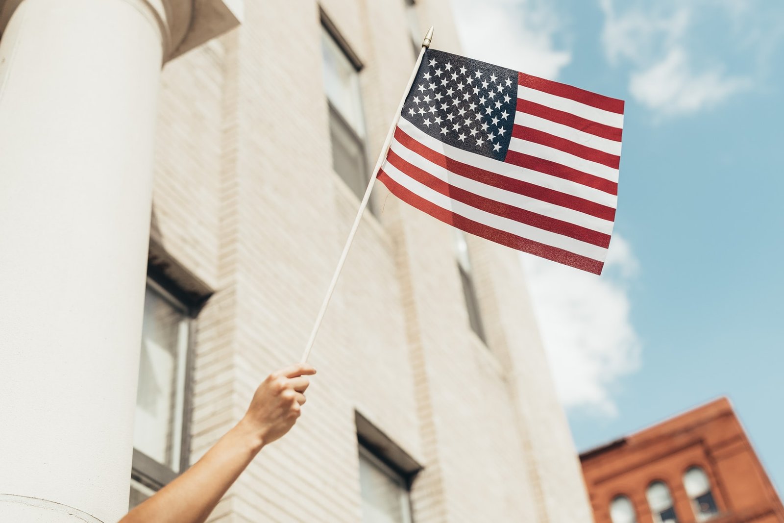 US flag waved from window