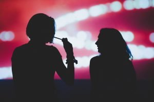 silhouette of two people smoking weed