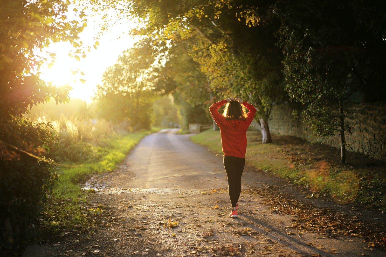 women running on country road at sunset