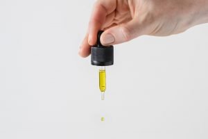 hand holding small oil dropper