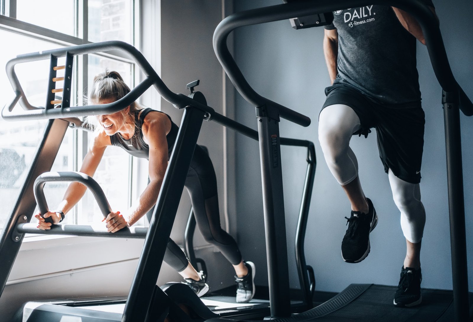 male and female on gym equipment