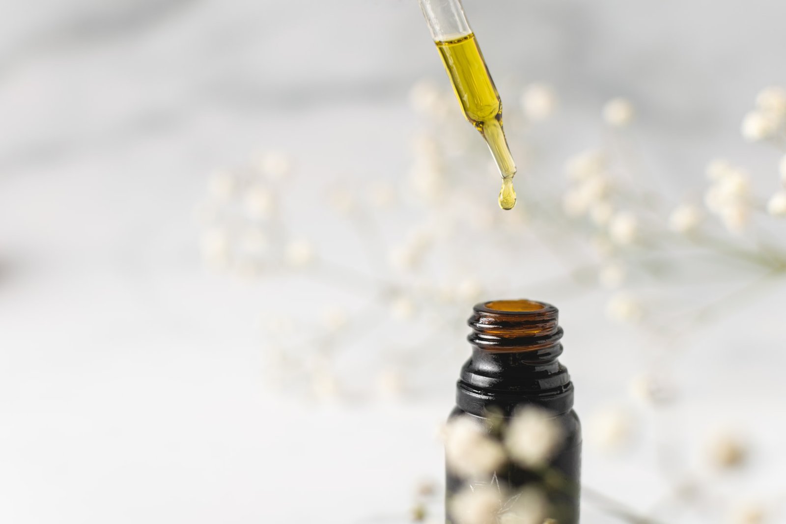 oil being dopped into small bottle