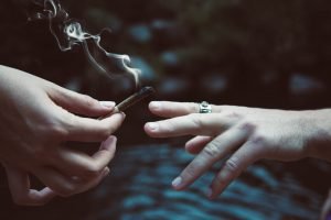 two hands passing a joint